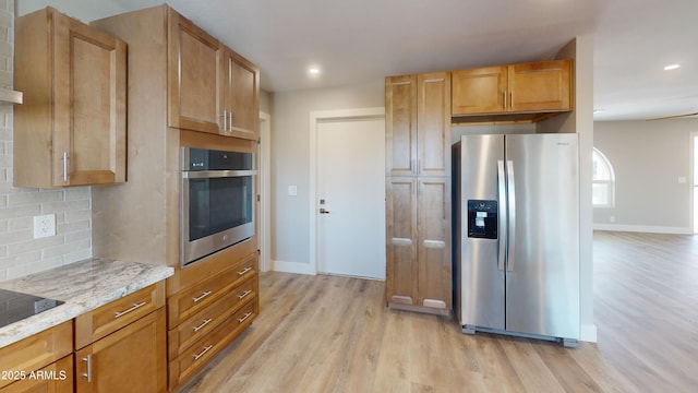 4151 E Clovis Ave, Mesa, AZ 85206 - kitchen with stainless steel appliances, light wood-style floors, decorative backsplash, baseboards, and light stone counters