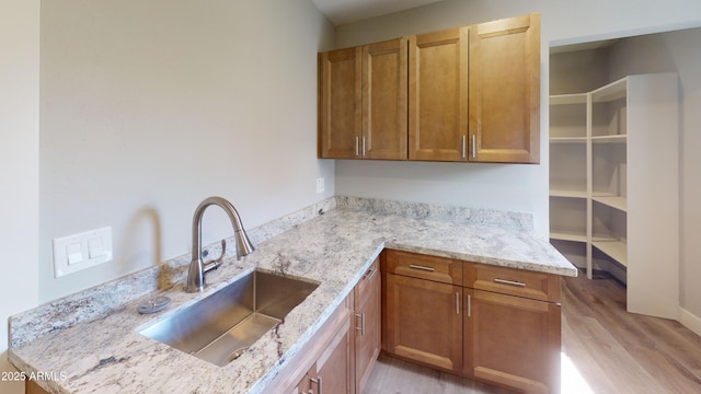 4151 E Clovis Ave, Mesa, AZ 85206 - kitchen featuring a sink, light wood-style flooring, light stone counters, and brown cabinetry