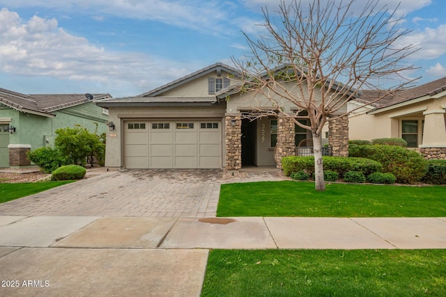 view of front facade featuring stucco siding, a front lawn, decorative driveway, stone siding, and a garage