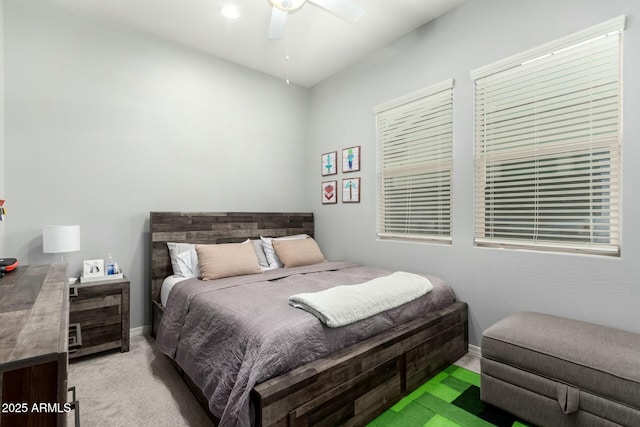 bedroom featuring a ceiling fan, baseboards, and light carpet