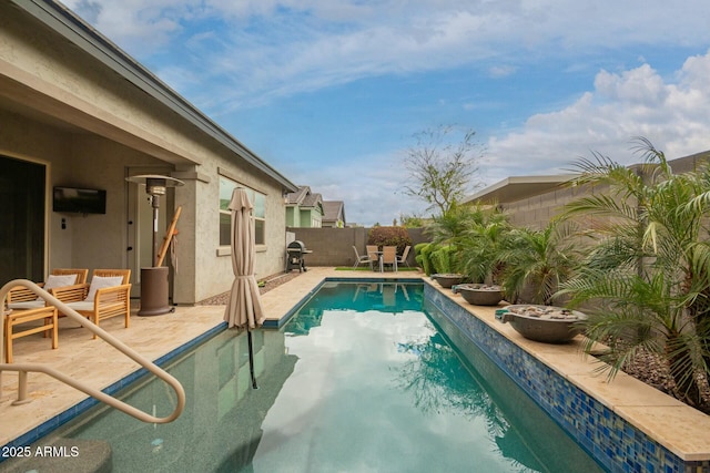 view of pool with a fenced in pool, a fenced backyard, and a patio area