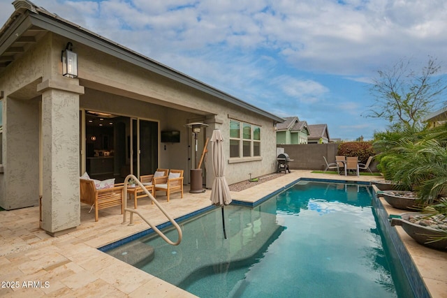 view of pool featuring a fenced in pool, fence, area for grilling, and a patio area