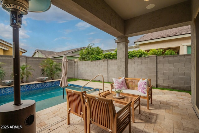 view of swimming pool featuring a fenced backyard, a fenced in pool, and a patio