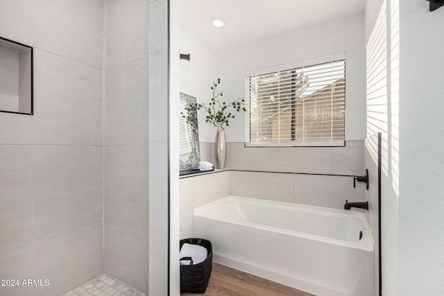 bathroom featuring hardwood / wood-style flooring and a tub