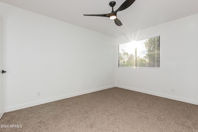 unfurnished room featuring ceiling fan and carpet floors