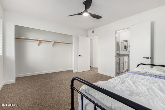 carpeted bedroom with a closet, ceiling fan, and ensuite bath