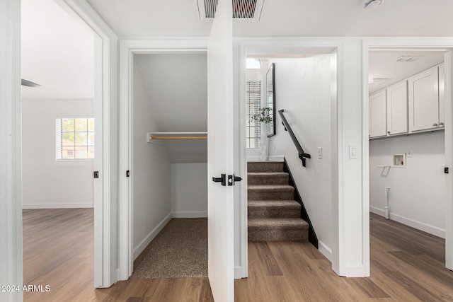 stairway featuring hardwood / wood-style floors