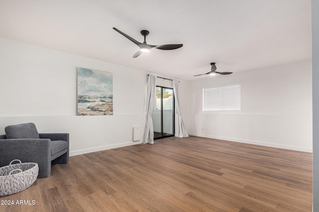 sitting room featuring wood-type flooring and ceiling fan