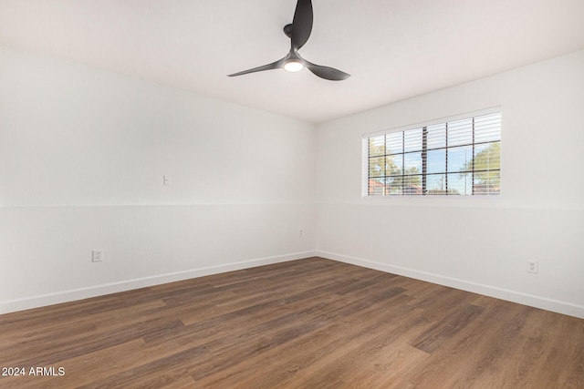 unfurnished room featuring dark hardwood / wood-style flooring and ceiling fan