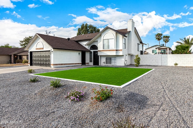 view of front facade with a garage and a front yard