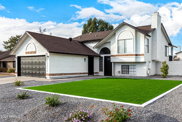 view of front facade with a front lawn and a garage