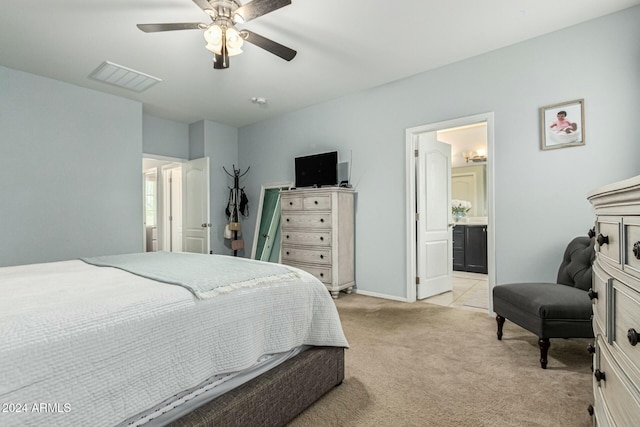 bedroom featuring visible vents, light carpet, connected bathroom, ceiling fan, and baseboards