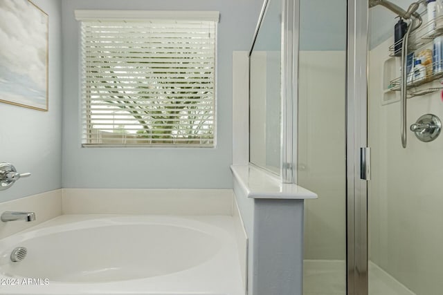 bathroom featuring a garden tub and a stall shower