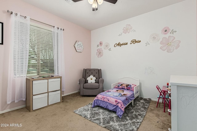 bedroom featuring baseboards, visible vents, a ceiling fan, and light colored carpet