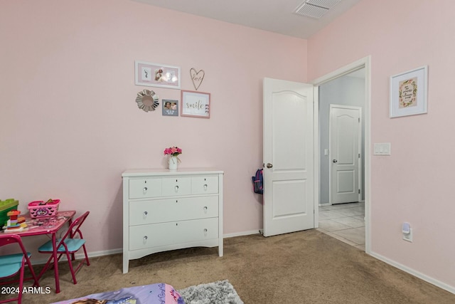 bedroom with baseboards, visible vents, and light colored carpet