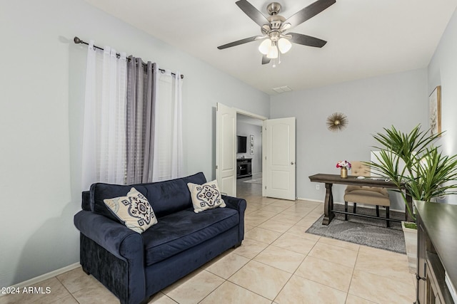 living room with visible vents, ceiling fan, baseboards, and light tile patterned floors