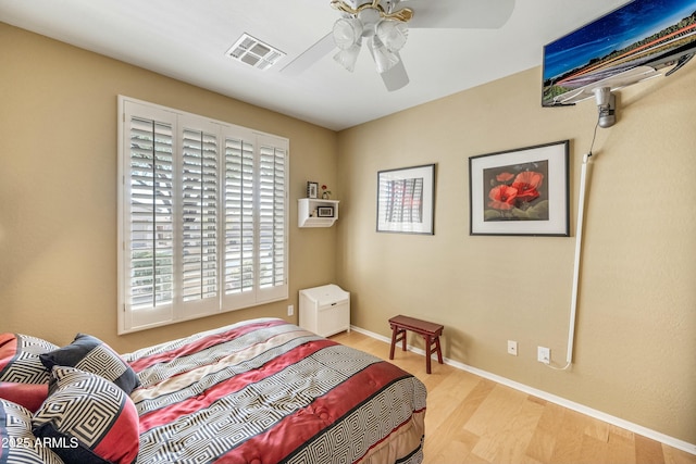 bedroom with ceiling fan and light hardwood / wood-style flooring