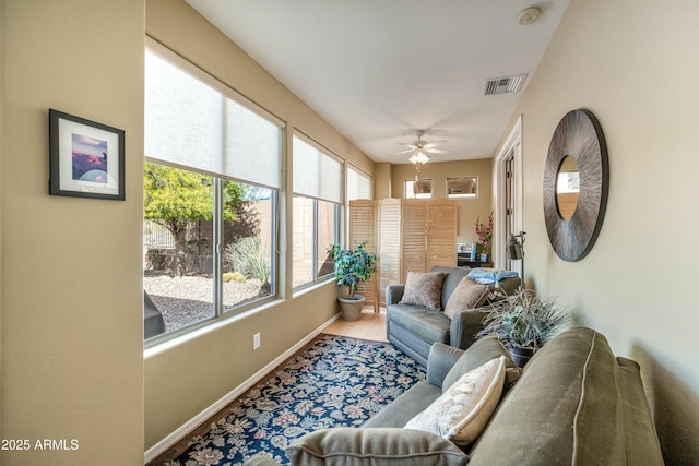 sunroom featuring ceiling fan