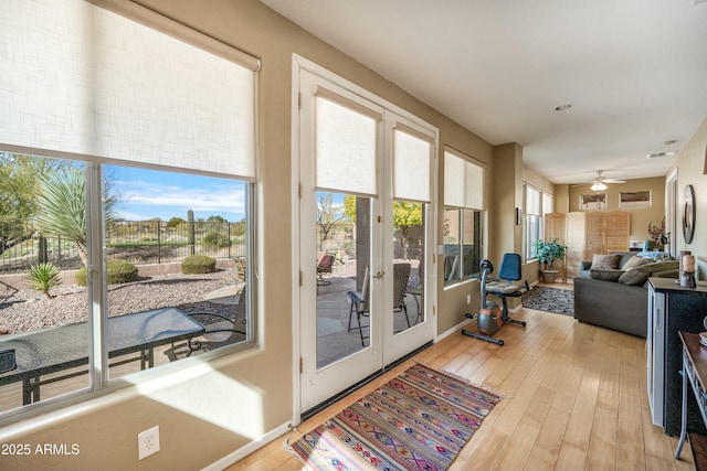 doorway to outside featuring ceiling fan and light hardwood / wood-style flooring