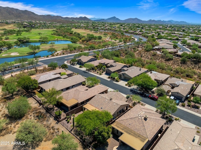 drone / aerial view featuring a water and mountain view