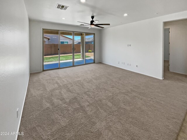 spare room with ceiling fan and carpet floors