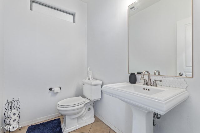 bathroom with tile patterned flooring, sink, and toilet