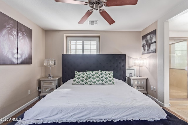 bedroom with ceiling fan and ensuite bath