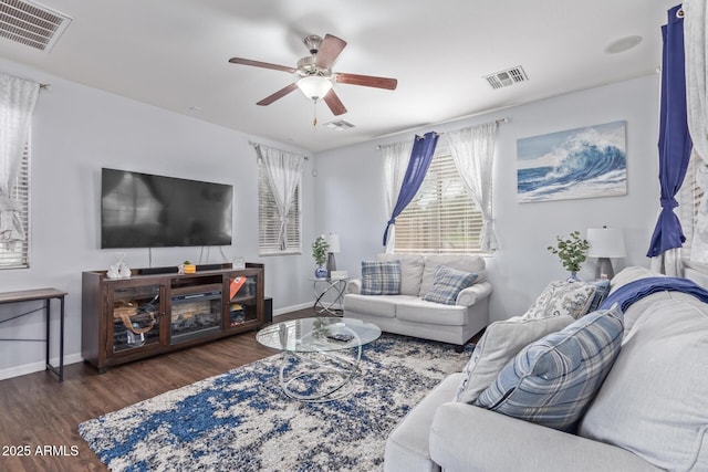 living room with dark wood-type flooring and ceiling fan