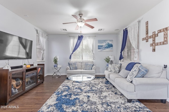 living room featuring dark hardwood / wood-style floors and ceiling fan