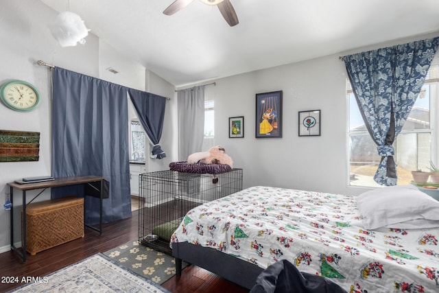 bedroom featuring ceiling fan, dark hardwood / wood-style flooring, and vaulted ceiling