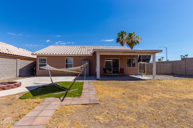 back of property with a patio