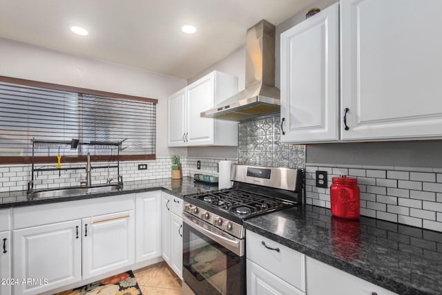 kitchen with sink, white cabinets, wall chimney range hood, and stainless steel range with gas stovetop