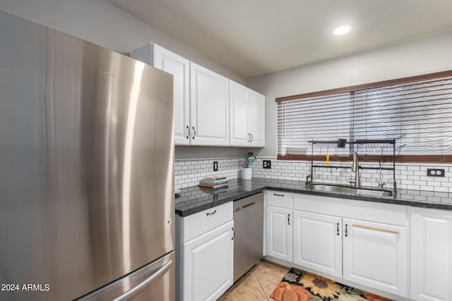 kitchen featuring sink, white cabinets, stainless steel appliances, and light tile patterned floors