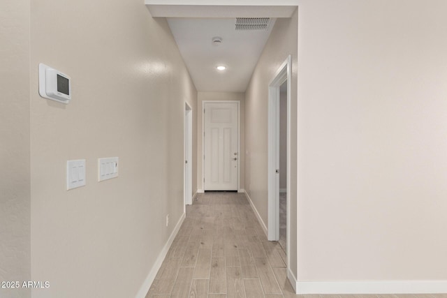 corridor with light hardwood / wood-style flooring