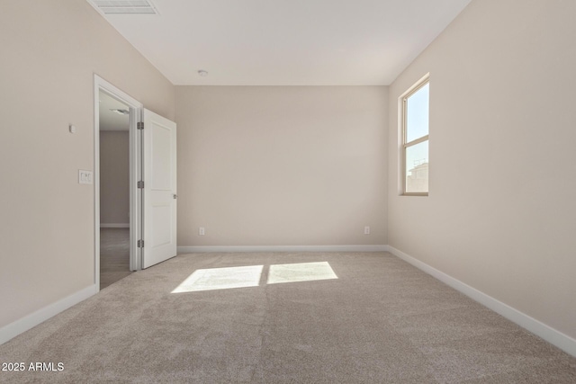 unfurnished room with light carpet