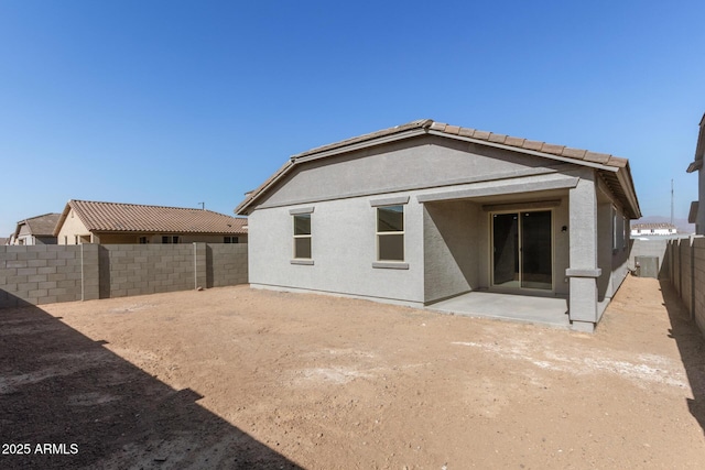 rear view of house with a patio and central AC