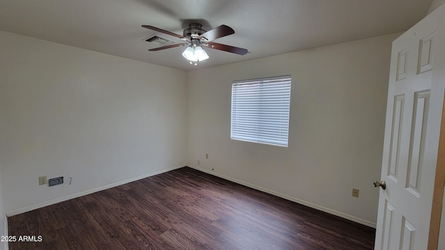 unfurnished room with dark wood-style flooring, a ceiling fan, and baseboards