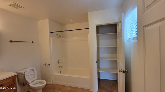 bathroom featuring tile patterned floors, toilet, shower / bath combination, and vanity
