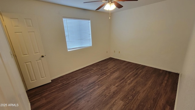 empty room with a ceiling fan, dark wood-style flooring, and baseboards