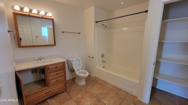 bathroom featuring tile patterned flooring, vanity,  shower combination, and toilet
