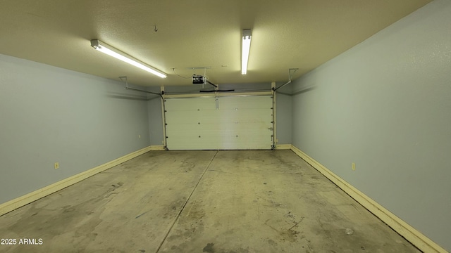 garage featuring baseboards and a garage door opener