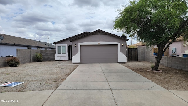 single story home featuring concrete driveway, an attached garage, stucco siding, and fence