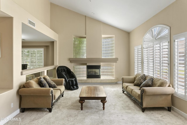 carpeted living area featuring visible vents and a wealth of natural light