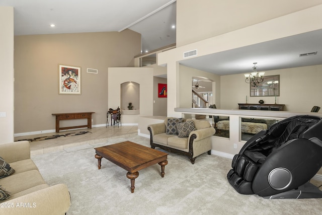 living area featuring high vaulted ceiling, visible vents, and baseboards