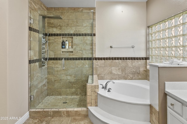 full bath featuring a shower stall, a bath, and vanity