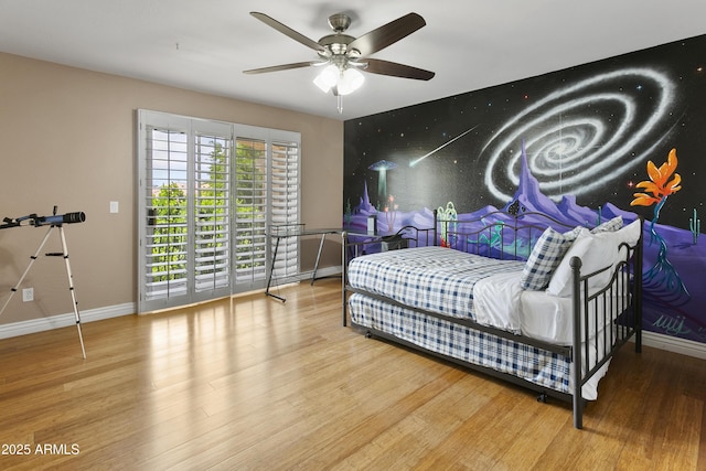 bedroom featuring baseboards, ceiling fan, wood finished floors, and access to outside