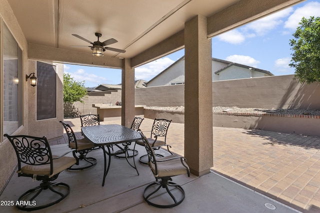 view of patio featuring a fenced backyard, a ceiling fan, and outdoor dining area