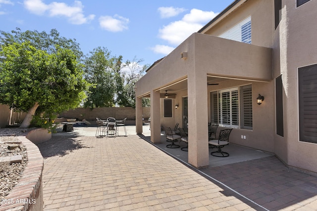 view of patio with a fenced backyard, outdoor dining space, and ceiling fan