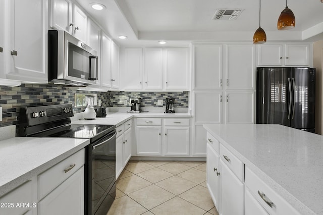 kitchen featuring light tile patterned flooring, white cabinetry, tasteful backsplash, visible vents, and black appliances