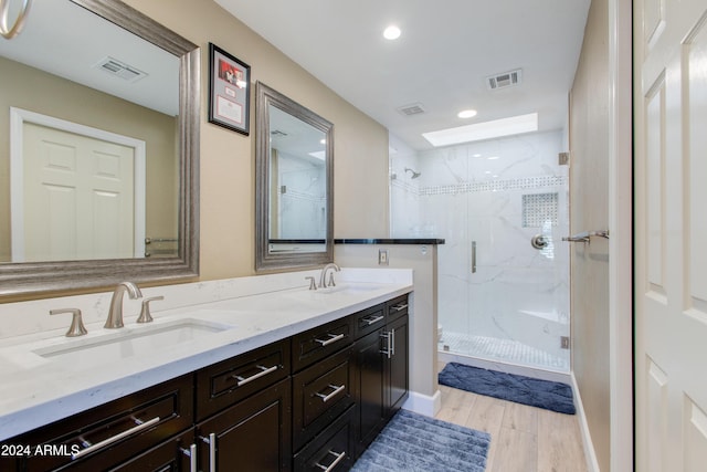 bathroom featuring hardwood / wood-style floors, vanity, and an enclosed shower